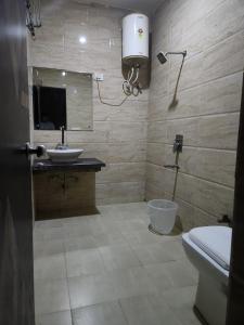 a bathroom with a sink and a toilet at Hotel City Lite Near IGI Airport Delhi in New Delhi
