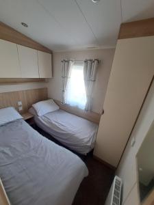 a small room with two beds and a window at 45 Sandringham in Blackpool