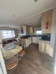 a kitchen with a table and chairs in a room at 45 Sandringham in Blackpool