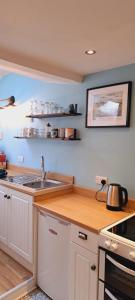 a kitchen with a sink and a counter top at Appleyard Cottage - Yorkshire Dales in Hellifield