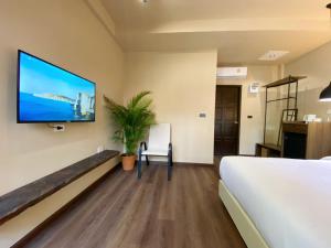 a hospital room with a tv on the wall at Suncloud Hotel Koh Samet in Ko Samed