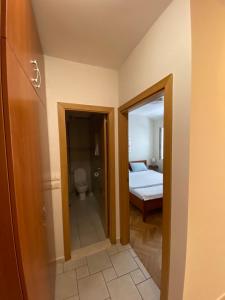 a room with a bedroom with a bed and a mirror at First line Apartment Petrovac in Petrovac na Moru