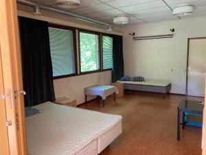 a hospital room with two beds and windows at Sippolantie 11 in Kouvola