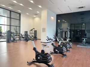 a gym with several treadmills and exercise bikes at KL Chambers Suites in Kuala Lumpur