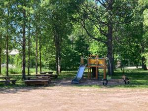 a playground with a slide and benches in a park at Sippolantie 11 in Kouvola
