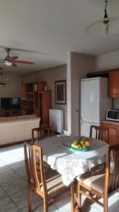 a kitchen with a table with a bowl of fruit on it at Corinas Holiday House in Chania