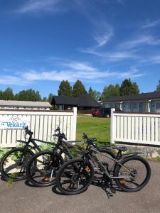 a group of bikes parked next to a white fence at Lomavekarit Apartments in Rovaniemi