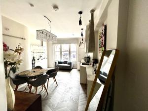 a kitchen and living room with a table and chairs at soho london suite in London