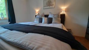 a large bed in a bedroom with two pillows at Ferienhaus Goldener Anker Unterach am Attersee in Unterach am Attersee