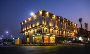 a large building with lights on top of it at Golden Rest Hotel in Al Khobar