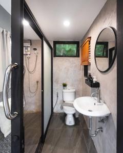 a bathroom with a sink and a toilet and a mirror at Naramountainkhaoyai 04 in Ban Tha Chang