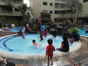 un groupe d'enfants jouant dans une piscine dans l'établissement 311 Pangkor Coral Bay Homestay, à Kampong Pasir Bogak 5 autres photos