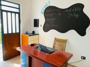 an office with a desk with a laptop on it at Adriatic Hostel Vlora in Vlorë