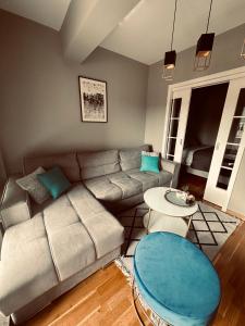 莫斯塔尔Apartment Blue Lagoon的客厅里有一张沙发和一张桌子。