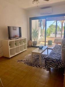 a living room with a tv and a couch at O Sole Mio in Albir