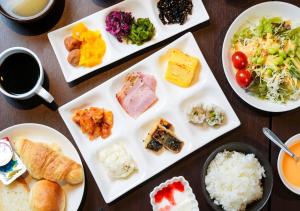 a table with several plates of food on it at APA Hotel Namba Shinsaibashi Nishi in Osaka