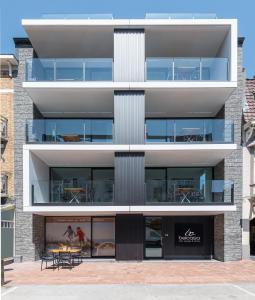 an external view of a building with a patio at Belcasa Mar Suites & Lofts in Middelkerke