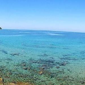 a large body of blue water with reefs at Agropoli Rooms in Agropoli