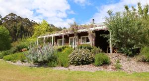 a house with a garden in front of it at Big Brook Retreat in Pemberton