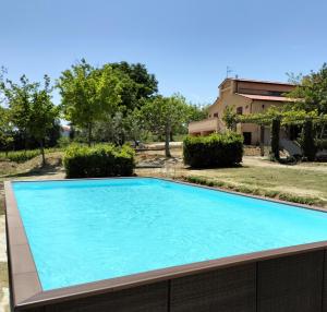 a swimming pool in a yard with a house at Angelucci Agriturismo con Camere e Agri Camping in Lanciano