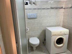 ein Badezimmer mit einem WC und einer Waschmaschine in der Unterkunft Bergamo Center in Bergamo
