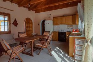 a kitchen with a wooden table and chairs in a kitchen at Tranquility Base in Neapoli Voion +45 photos