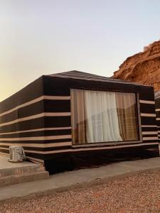 a black and white building with a window at Harir Rum luxury camp in Wadi Rum