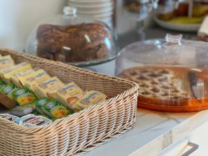 a counter with two baskets of bread and other food at Minerva Monks Inn in Rome