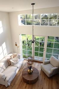 a living room with a couch and a table at Gäststuga 30 kv + loft in Vallentuna