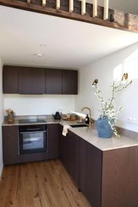 a kitchen with a sink and a counter top at Gäststuga 30 kv + loft in Vallentuna