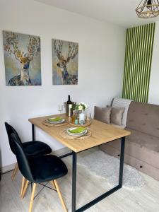 a dining room table with a black chair and a table at Bella Vista Cheia in Cheia +22 photos