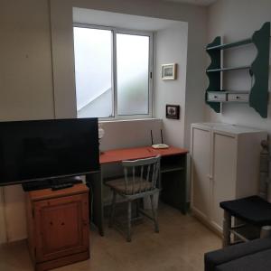 ein Zimmer mit einem Schreibtisch mit Fernseher und einem Fenster in der Unterkunft One bedroom apartment in Tazacorte in Tazacorte