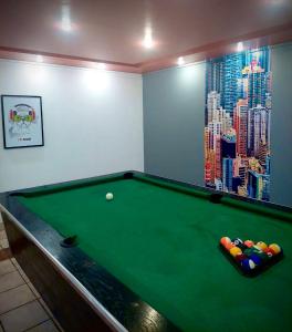 a billiard room with a green pool table at Ondraszek in Ustroń