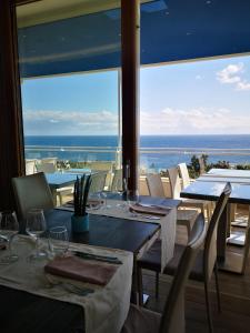 a dining room with tables and chairs with a view of the ocean at Casa Teresa in Tricase