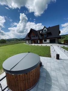 a ping pong table in front of a house at Hill House Apartamenty in Białka Tatrzanska