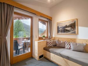 a room with a couch in front of a window at Landhaus Casper in Gerlos +13 photos