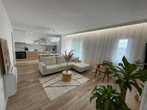 a living room with a white couch and a kitchen at Myslym Shyri's Apartments in Tirana +44 photos