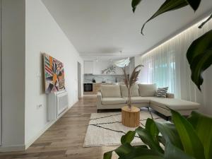 a living room with a couch and a table at Myslym Shyri's Apartments in Tirana