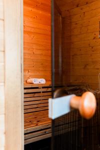 a sauna with a wooden wall and a wooden door at VILLA BRATTHOLMEN in Brattholmen