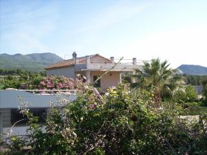una casa con un balcón con flores rosas. en Casa Trotamundos, en Moratalla