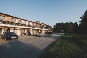 a car parked on a road next to a building at Serenity Lipno in Lipno nad Vltavou