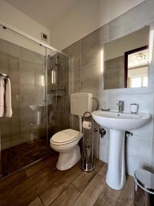 a bathroom with a toilet and a sink at Hotel Pineta in Laigueglia