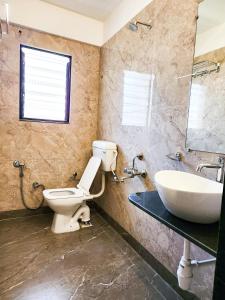 a bathroom with a toilet and a sink at Hotel Rajwada Aurangabad in Aurangabad