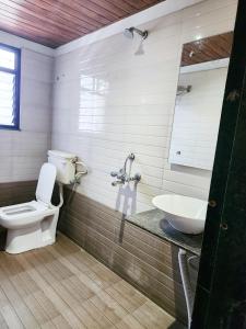 a bathroom with a toilet and a sink at Hotel Rajwada Aurangabad in Aurangabad