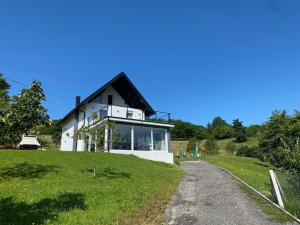 a house on a grassy hill with a pathway at Relax House Banja Luka in Banja Luka