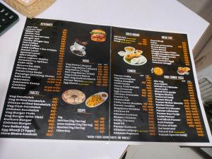 un menu pour un restaurant sur une table dans l'établissement MangalMurti Himalyan Hotel, à Almora