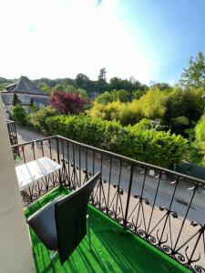 a balcony with a table and chairs and a view at Les gentianes in Alby