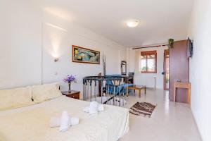 a bedroom with a bed and a living room at Erifili Kallithea in Kallithea Halkidikis