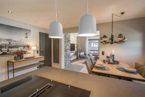 a kitchen and living room with a table and a dining room at Bergwiesenblick in Oberstdorf