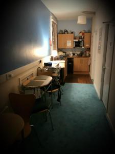 a room with tables and chairs in a kitchen at Hull Trinity Backpackers in Hull